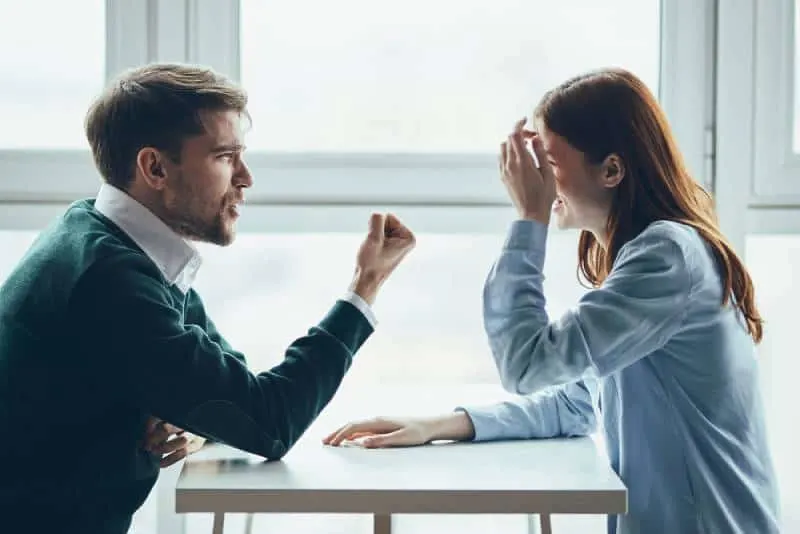 couple sitting at table and arguing