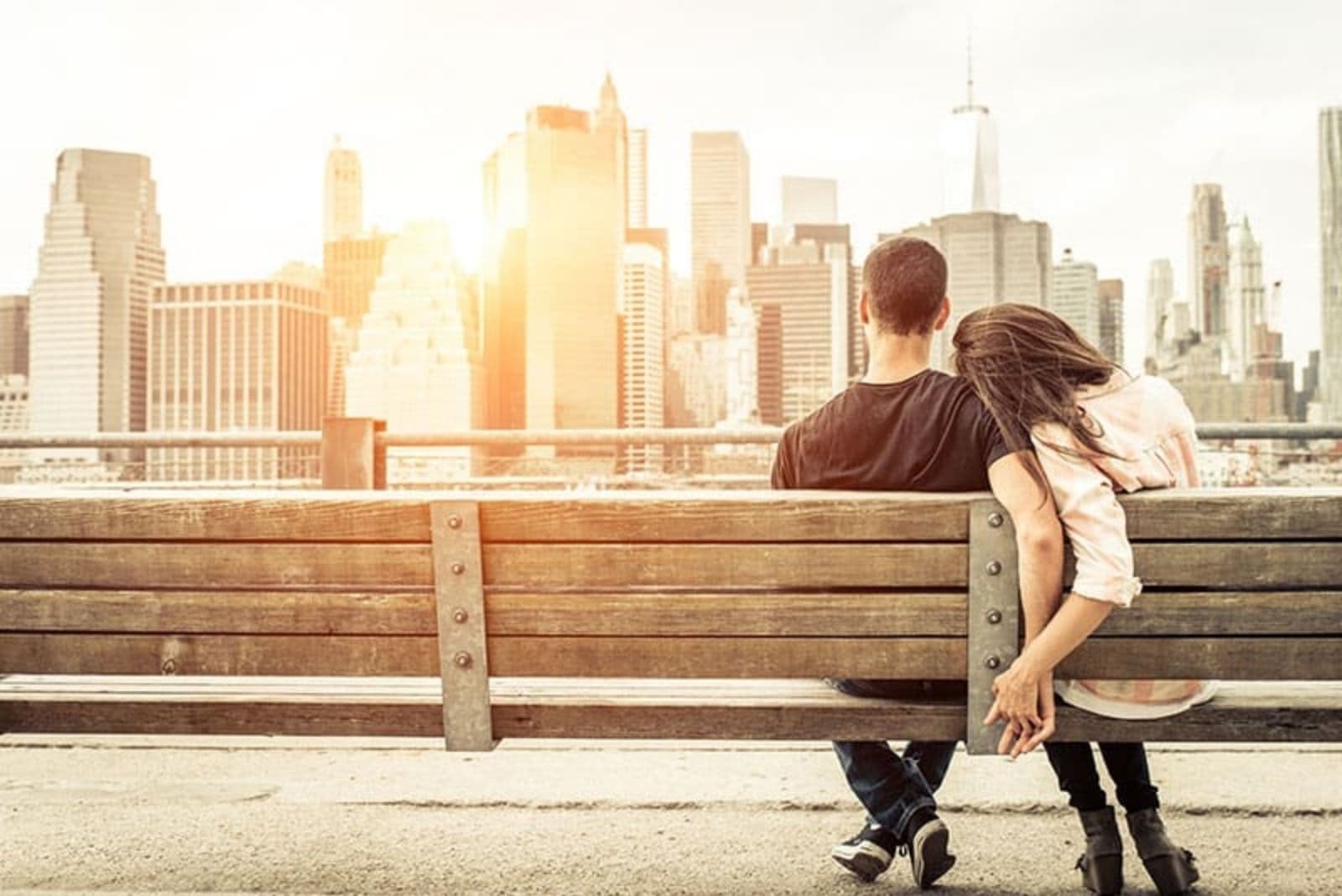 couple sitting on the bench and holding hands