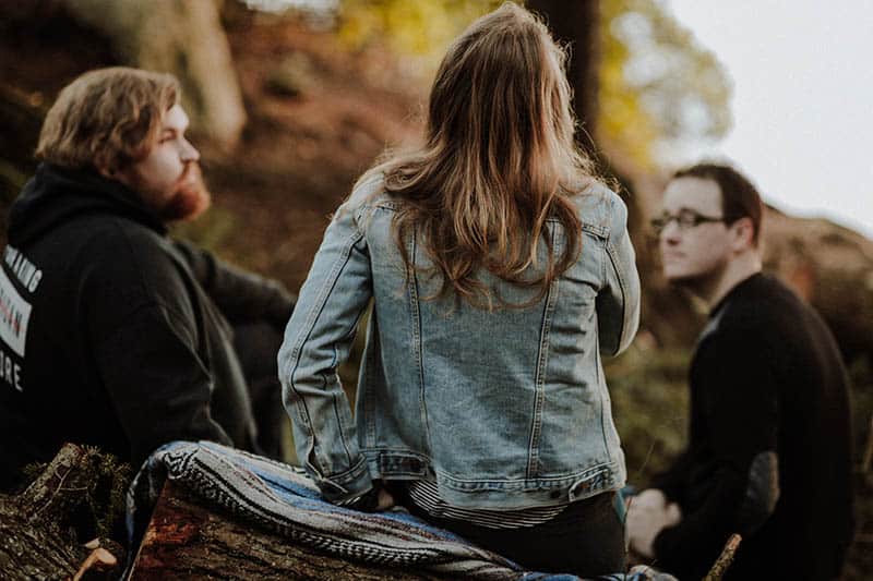 group of friends sitting in nature