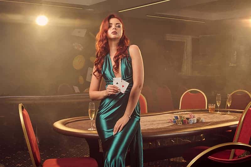 handsome woman holding cards in casino