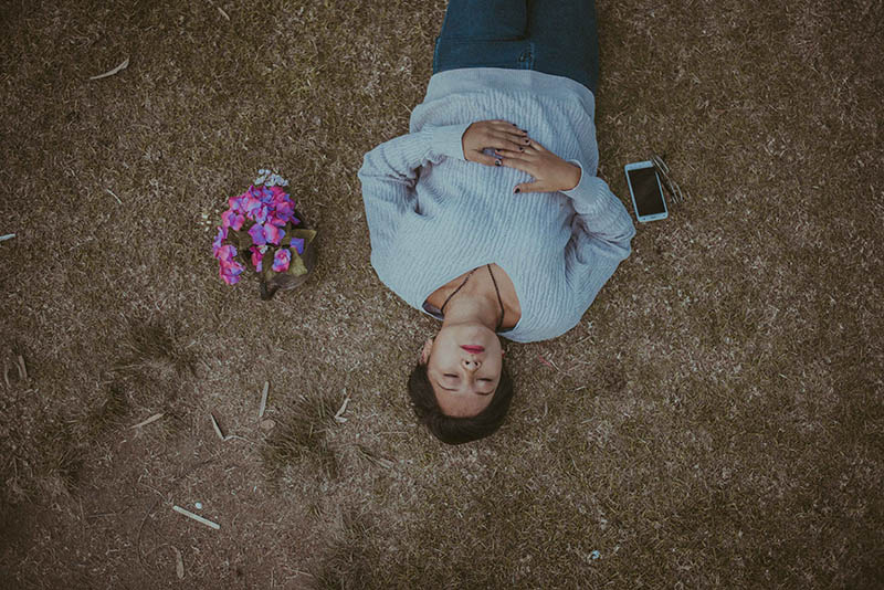 high angle of woman lying on surface outside