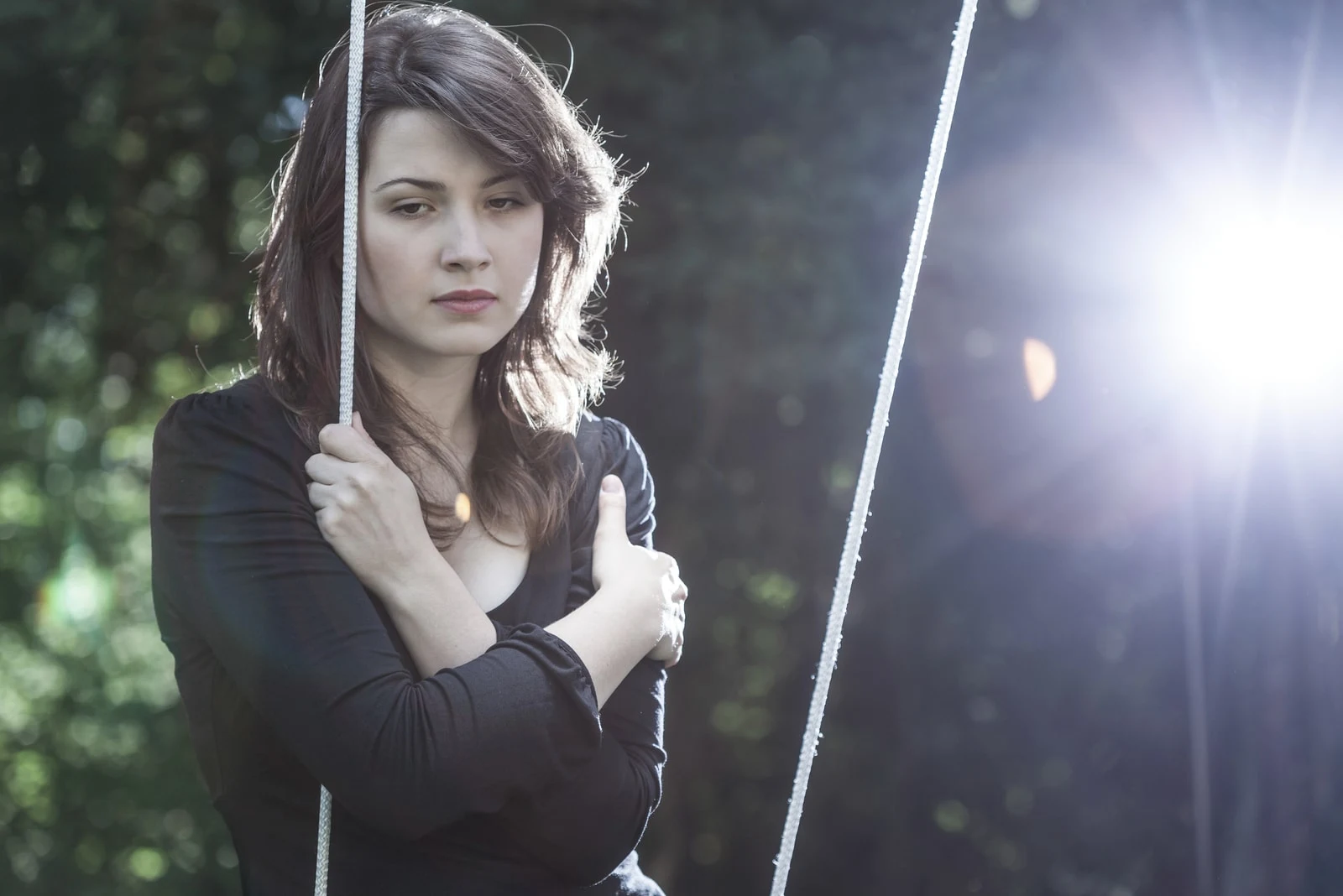 lonely pensive young woman standing alone
