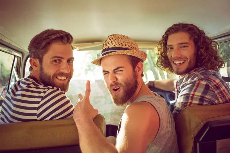 male friends posing in the car