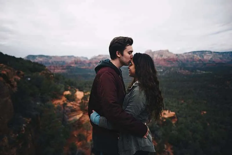 man kisses woman forehead