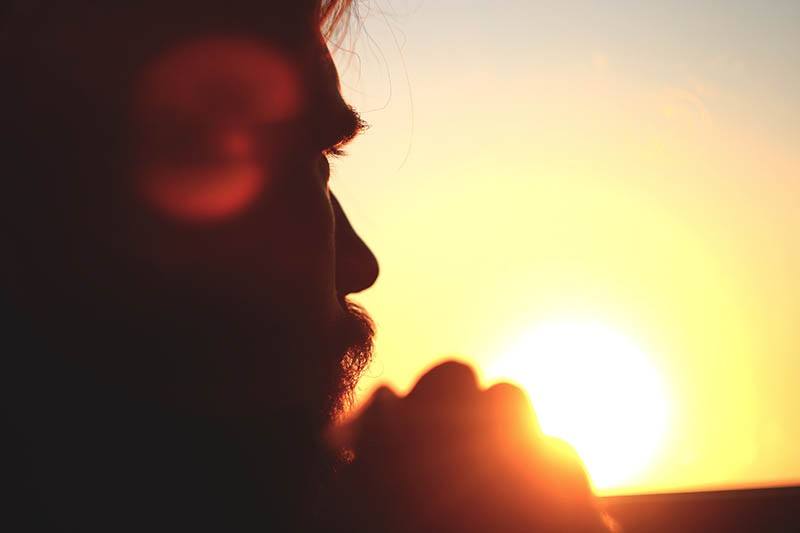 man looking at sunset