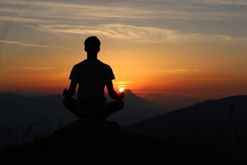 man meditates in nature