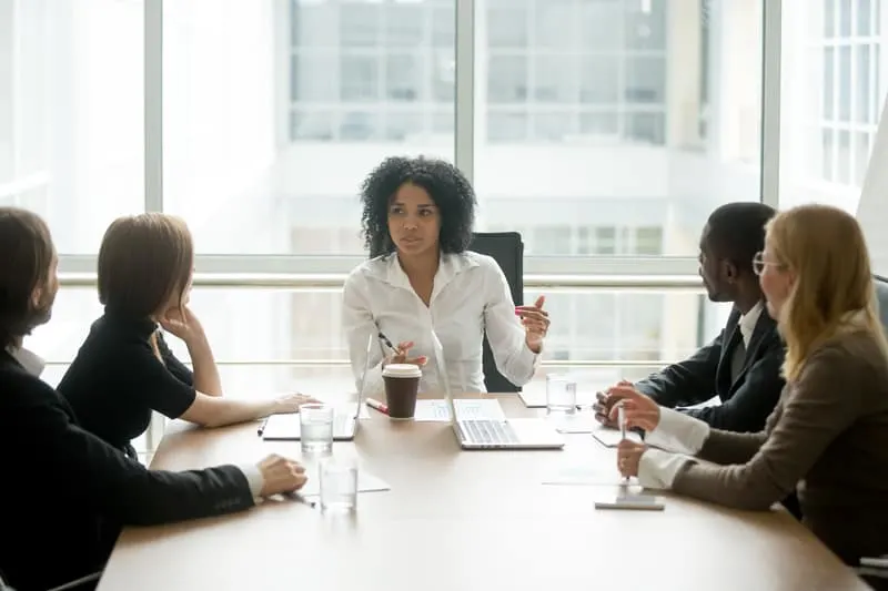 female boss leading corporate multiracial team 