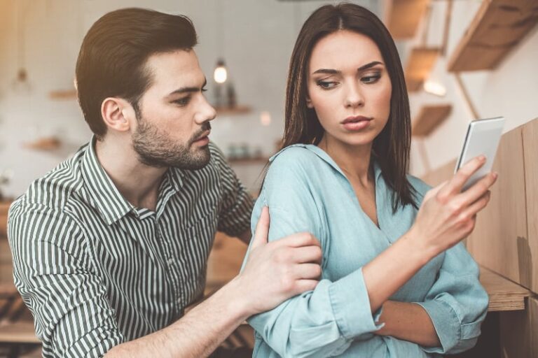 man holds woman for arm