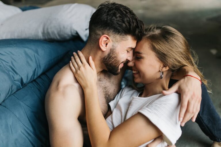 beautiful loving couple kissing in bed