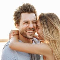 Beautiful couple, stunning emotions, on a yacht at sunset on the sea