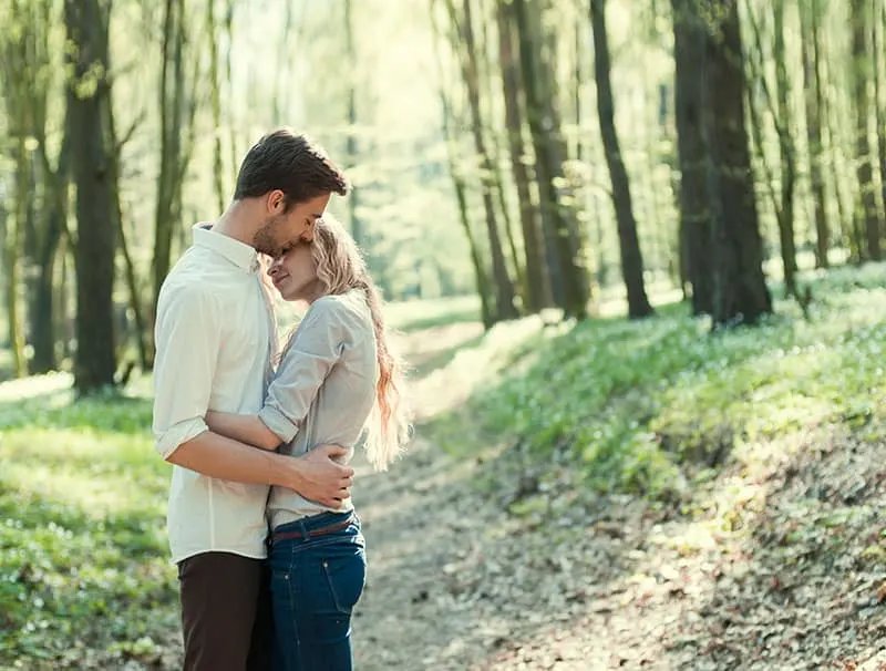 beautiful young couple hugging in the park 