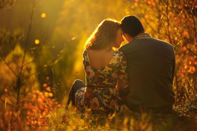 passionate love in the autumn park. A young couple. Sitting in a winter fairy and the magical forest