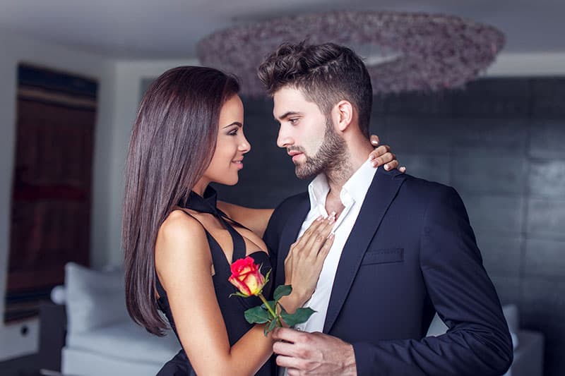 Young man give rose to lover indoor, couple in love 