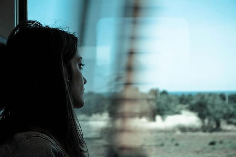 Sad woman traveling with train