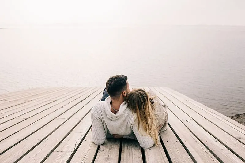 couple hugging on a pier