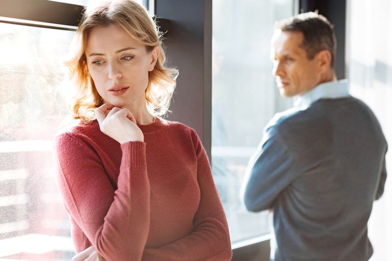 Nice unhappy young woman standing together and turning away from each other