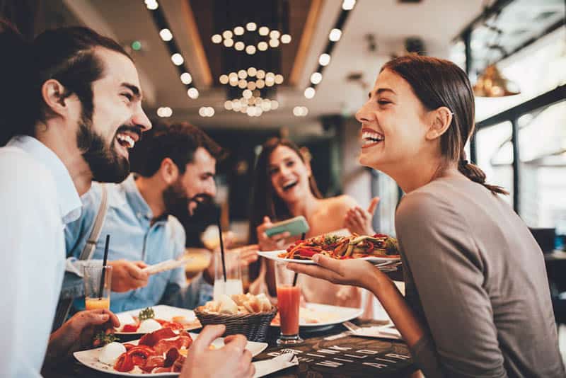 smiling friends at restaurant