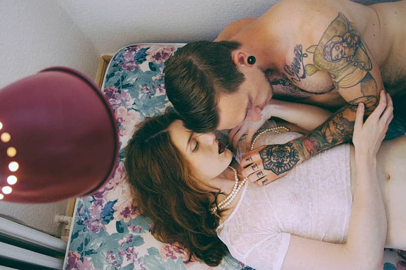 tattoo man cuddling with woman