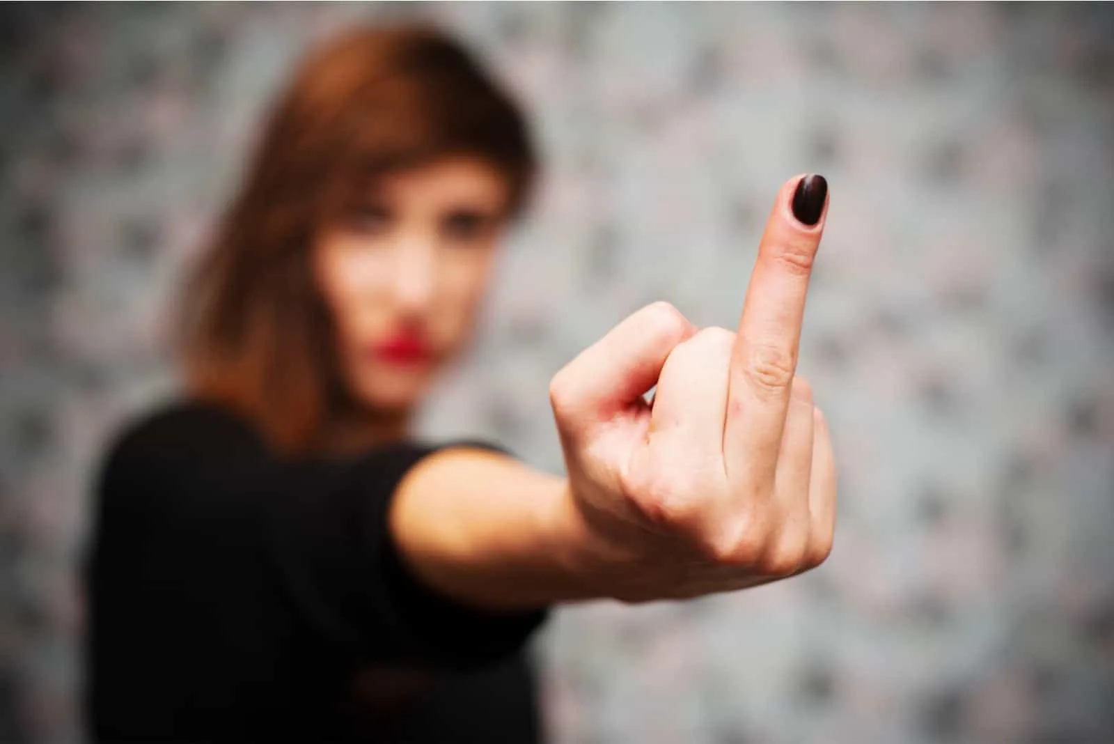 the girl points her middle finger at someone