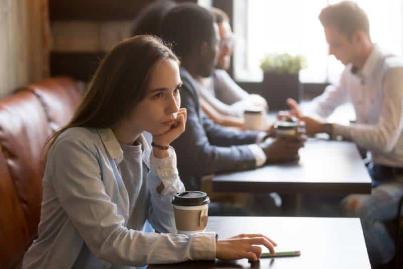 upset girl sitting at cafe