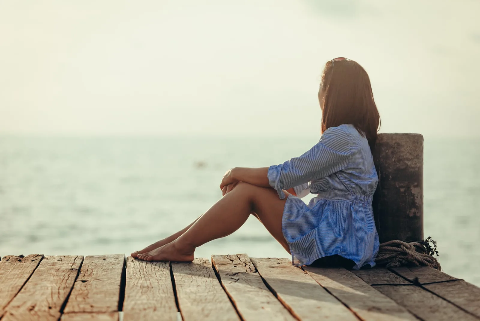 woman sitting alone near the sea