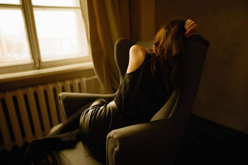 worried girl sitting on sofa