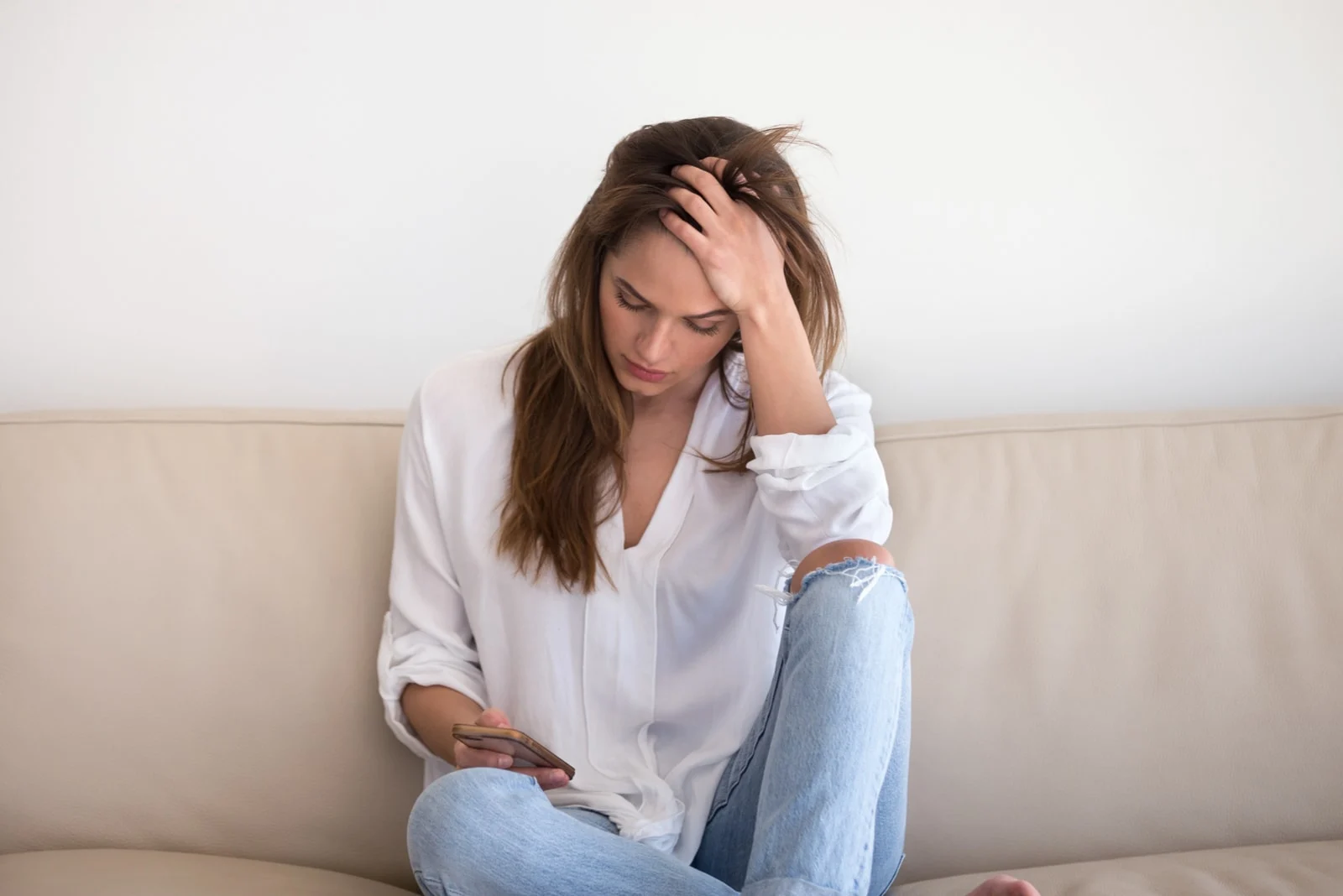 worried woman texting on the mobile phone