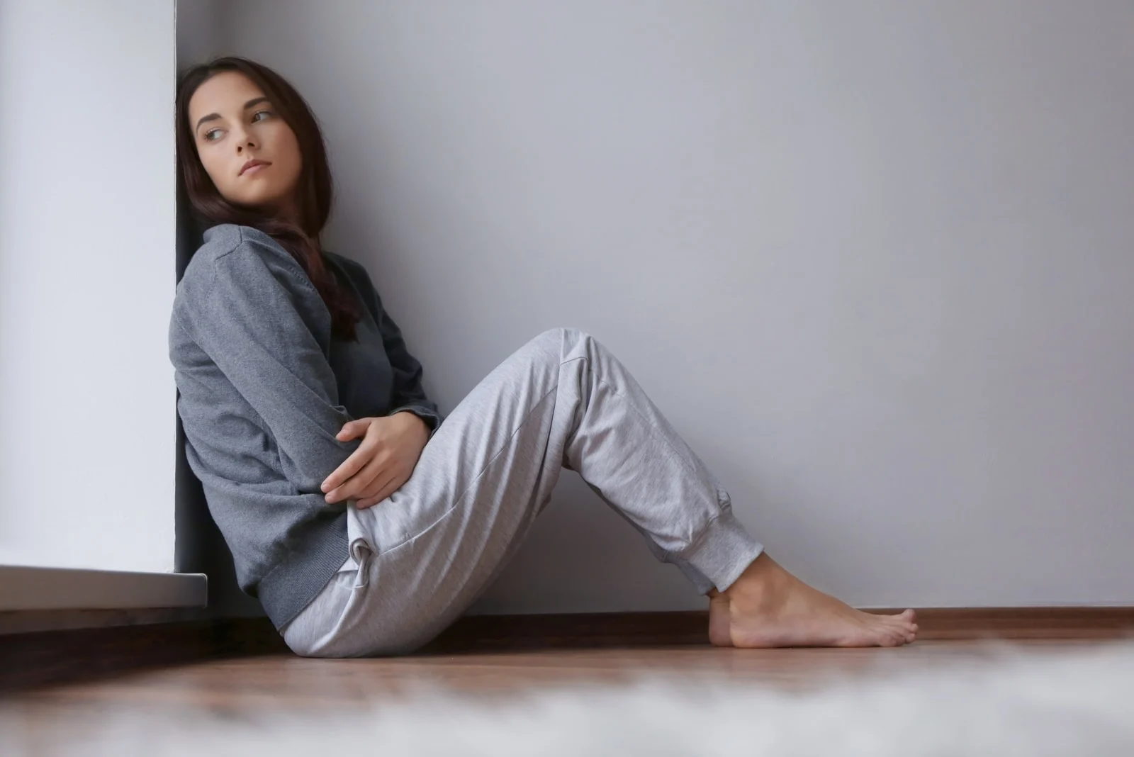 young sad woman sitting on the floor