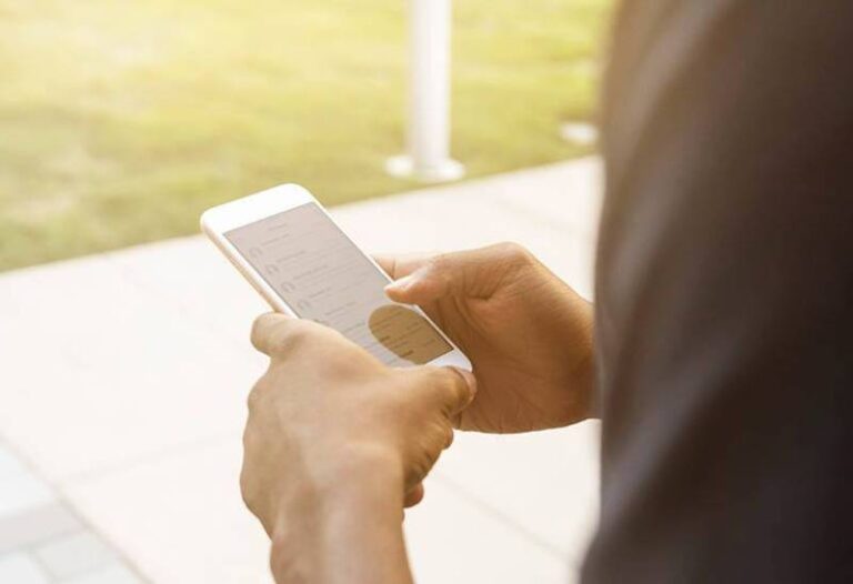 close up photo of man typing on his phone