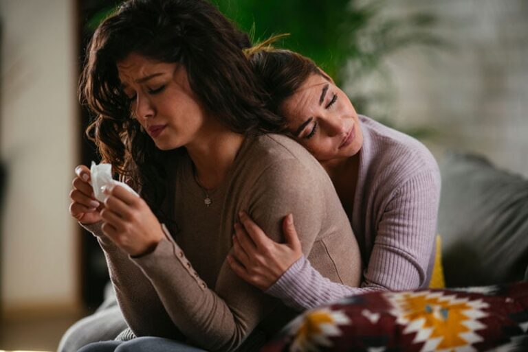 woman comforting crying friend