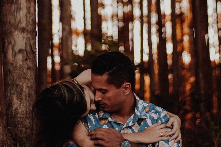 woman hugging a man beside tree