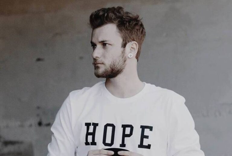 man wearing white shirt and looking at distance