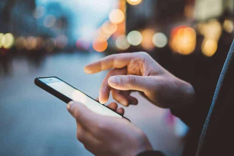 close up photo of man typing on his phone
