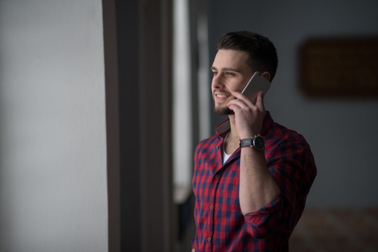 the man stands and talks on the phone