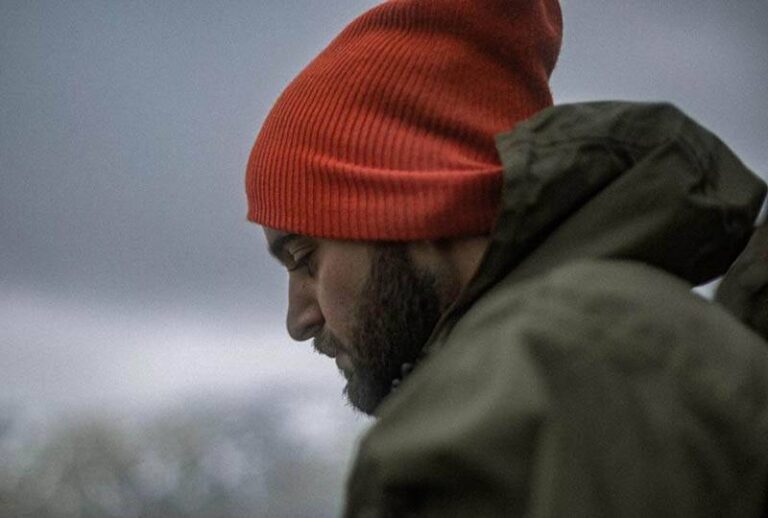side view of man wearing red hat
