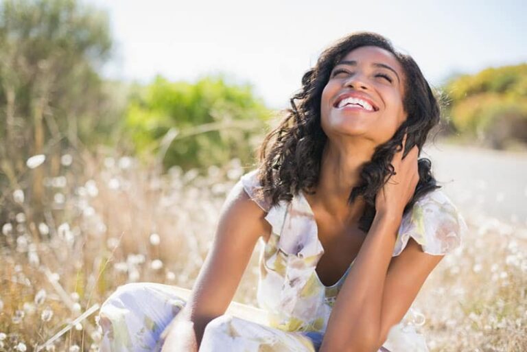 georgeous woman smiling in the meadow