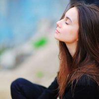 young woman taking deep breath