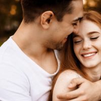 young lovely couple hugging outside