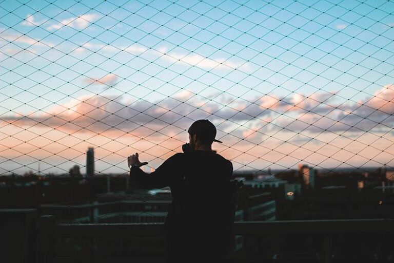 silhouette of man looking at city