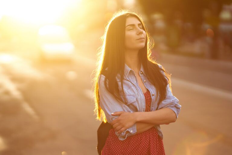 young woman standing in sunlight