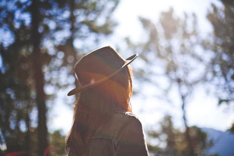 woman wearing hat and looking at distance outside