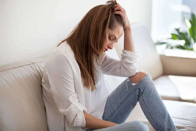 Sad thoughtful young woman feeling bad at home,