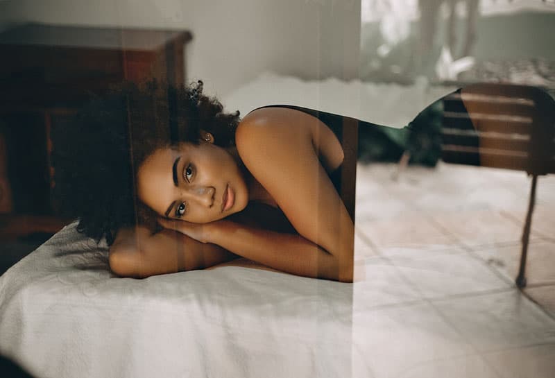 beautiful woman laying on bed