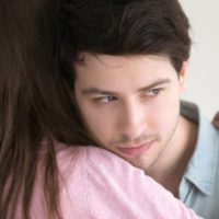 thoughtful man leaning on woman shoulder