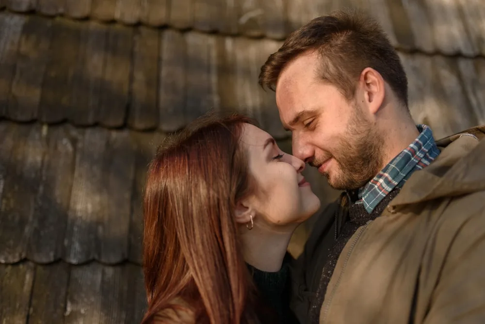 a loving couple hugging and kissing outside