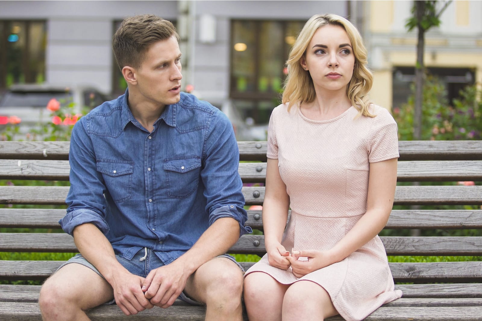a man and a blonde break up on a park bench