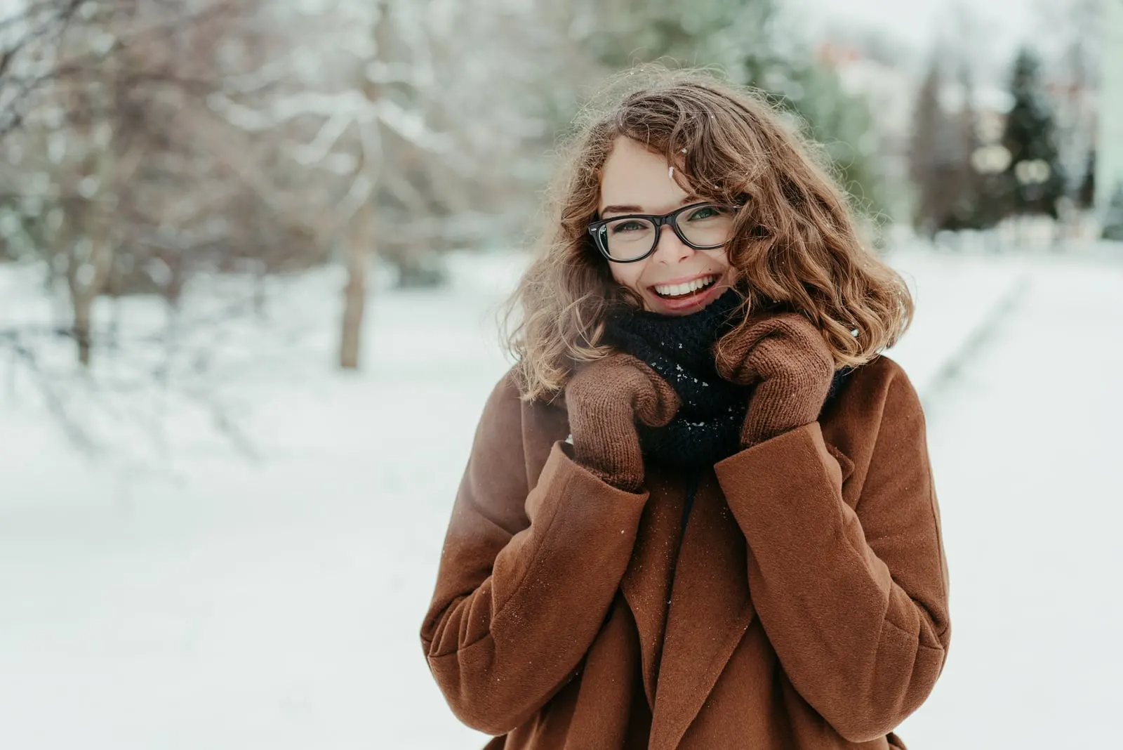 a smiling brunette enjoys a snowy idyll