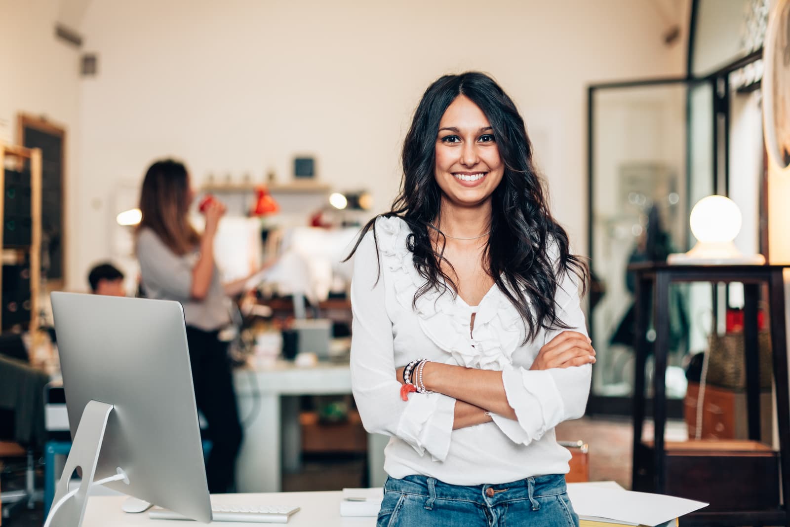 a woman with long black hair laughs