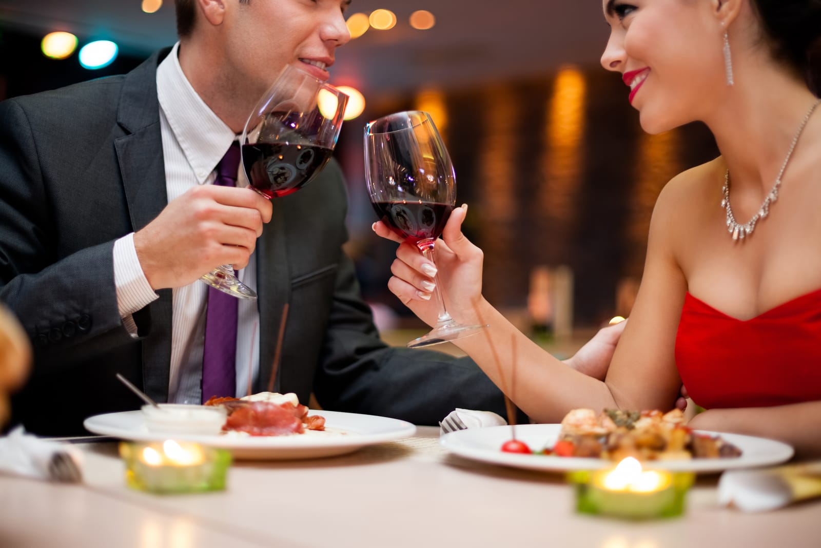 an attractive loving couple having dinner at a restaurant