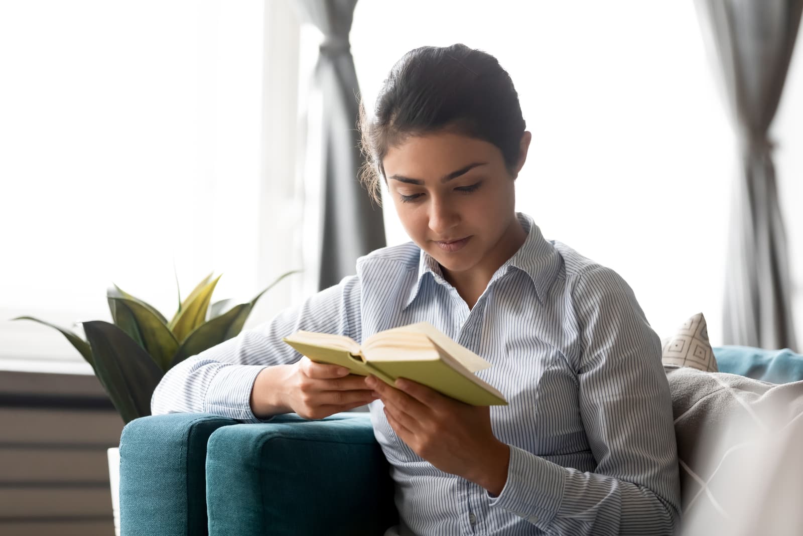 beautiful young woman reading book